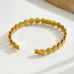 gold plated floral bangle style bracelet